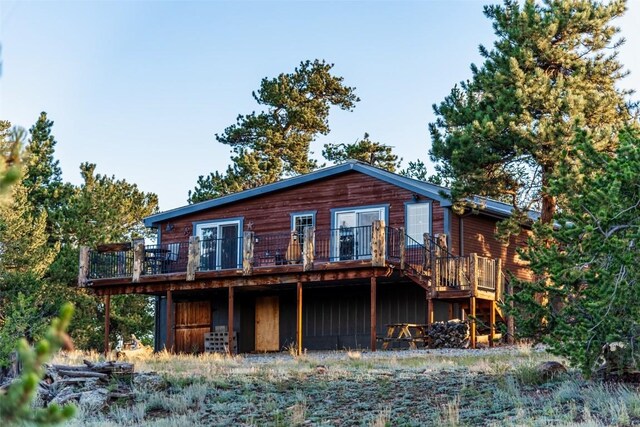 back of house with a wooden deck