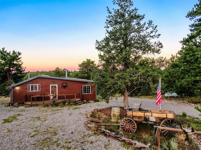 back house at dusk with a deck