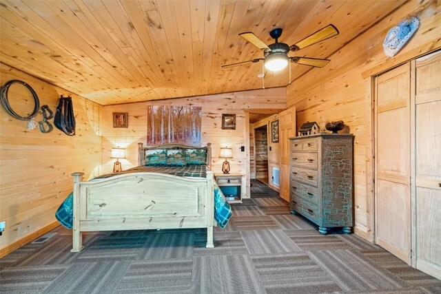 unfurnished bedroom with wooden walls, ceiling fan, wooden ceiling, and vaulted ceiling