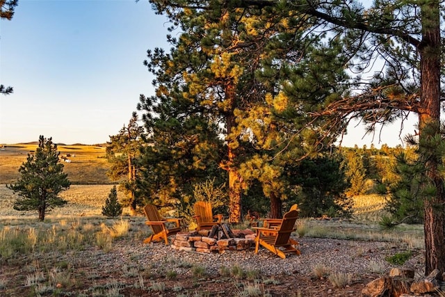 view of yard with a rural view and a fire pit