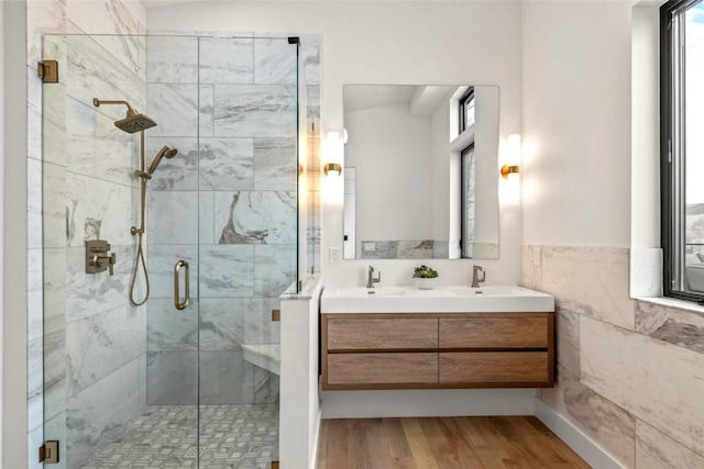 bathroom featuring wood-type flooring, an enclosed shower, and vanity