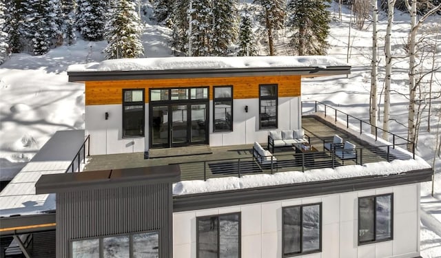 snow covered deck featuring an outdoor living space