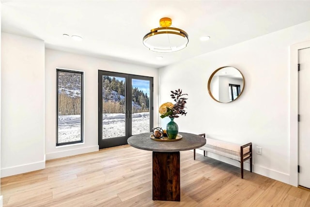 dining area featuring french doors and light wood-type flooring