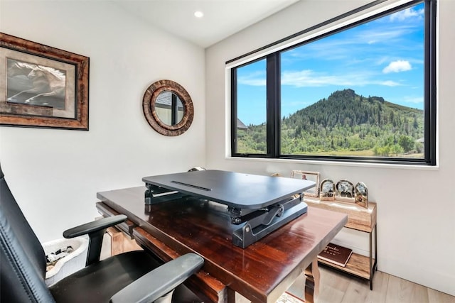 home office featuring baseboards, recessed lighting, a mountain view, and light wood-style floors