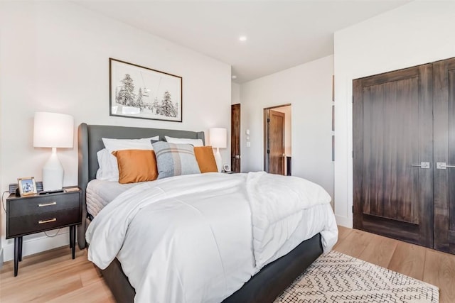 bedroom with light wood-style floors, baseboards, and recessed lighting