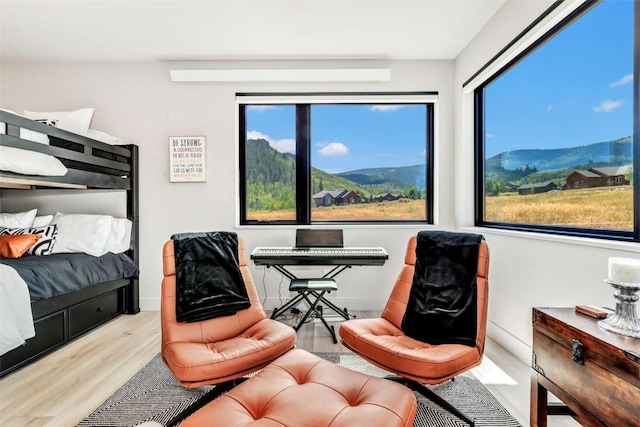 bedroom featuring baseboards and wood finished floors