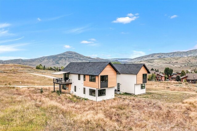 exterior space with a balcony and a mountain view