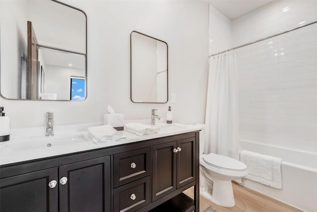 full bath featuring toilet, shower / bath combo, double vanity, and a sink