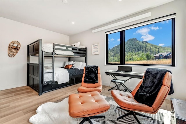 bedroom featuring baseboards and wood finished floors