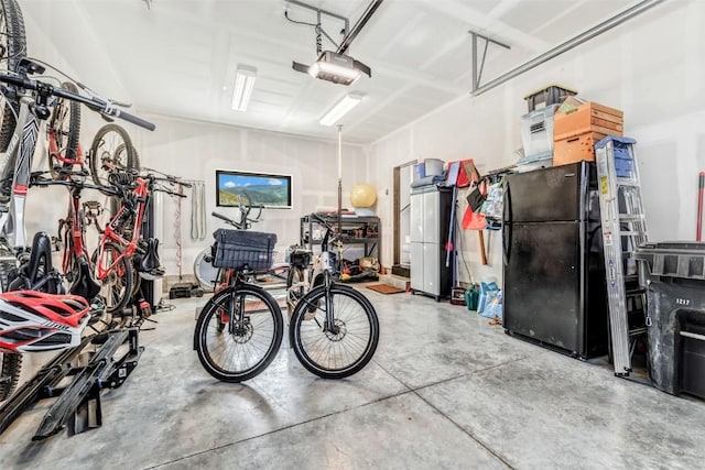 garage featuring bike storage, freestanding refrigerator, and a garage door opener