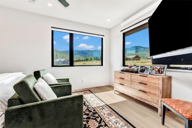 living room with a healthy amount of sunlight, light wood-style floors, ceiling fan, and recessed lighting