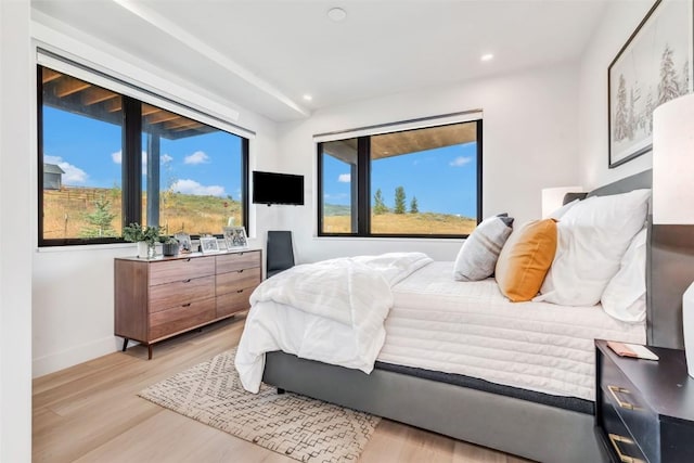 bedroom with baseboards, recessed lighting, and light wood-style floors