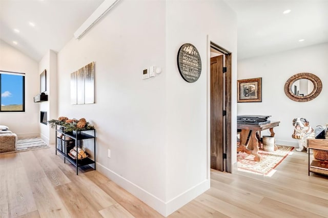 hall featuring recessed lighting, light wood-style flooring, and baseboards