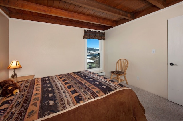 bedroom with carpet, beam ceiling, and wood ceiling