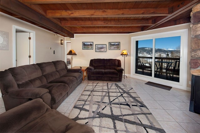 tiled living room with a mountain view, beam ceiling, and wooden ceiling