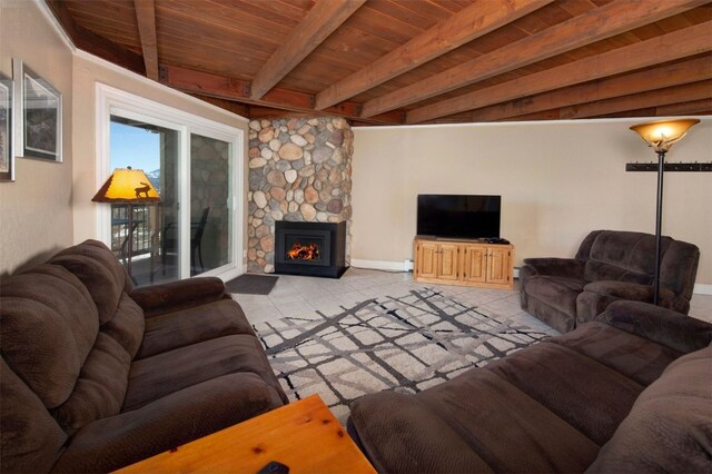 tiled living room featuring beamed ceiling, a stone fireplace, and wood ceiling