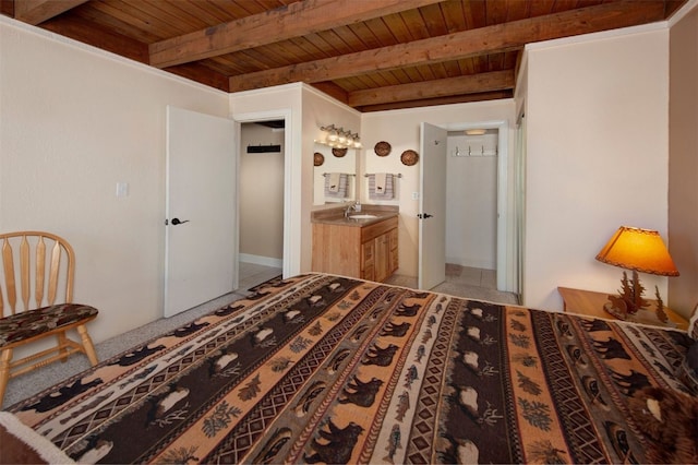 bedroom featuring beamed ceiling, wood ceiling, and sink