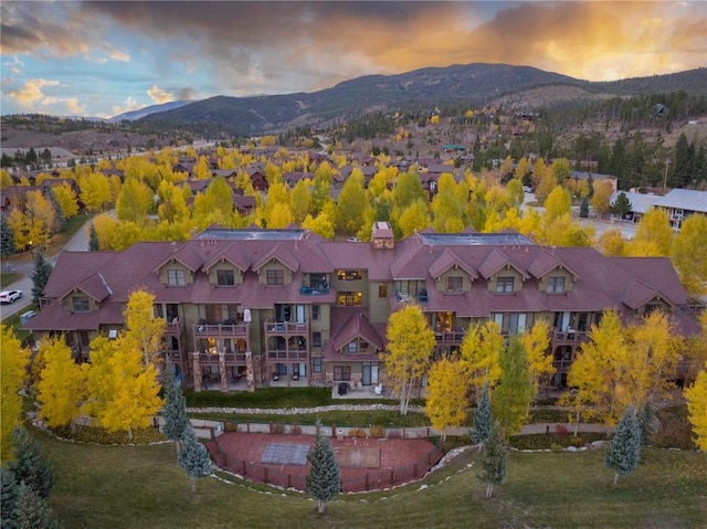 aerial view at dusk featuring a mountain view