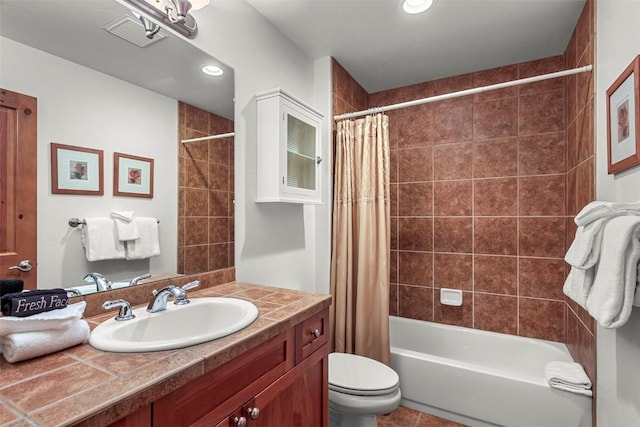 full bathroom with tile patterned flooring, shower / bath combination with curtain, vanity, and toilet