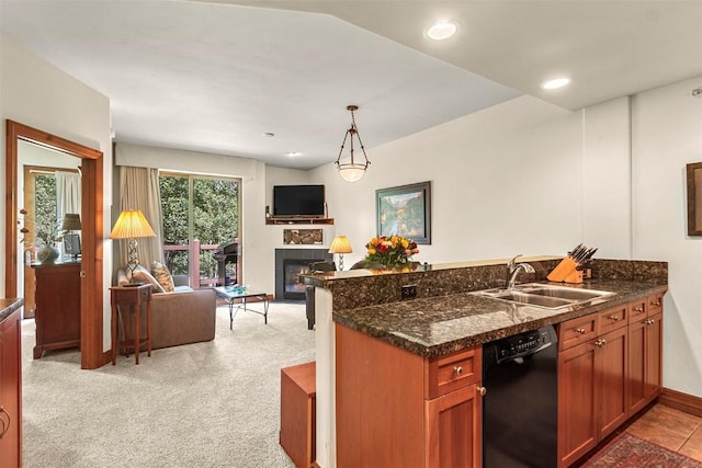 kitchen with light colored carpet, sink, a tile fireplace, decorative light fixtures, and black dishwasher