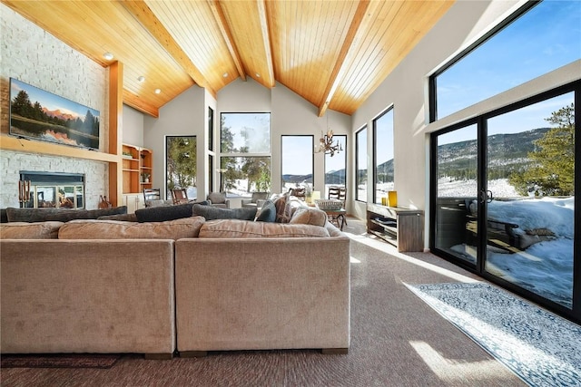 living room with beamed ceiling, a mountain view, wooden ceiling, and high vaulted ceiling