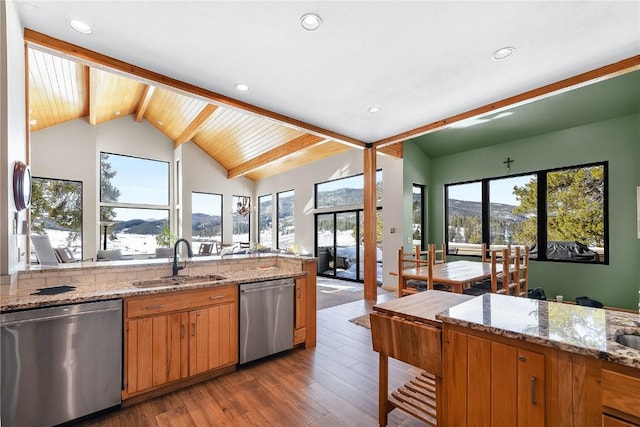 kitchen with a mountain view, sink, stainless steel dishwasher, and light stone counters