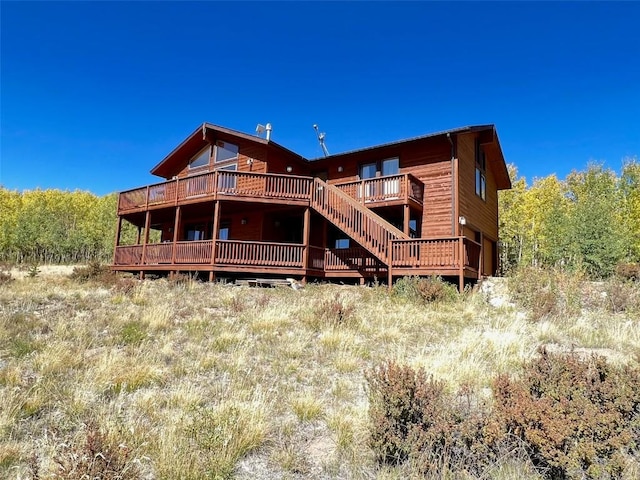 rear view of house with a wooden deck