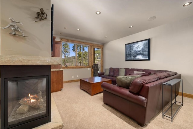 carpeted living room featuring a high end fireplace