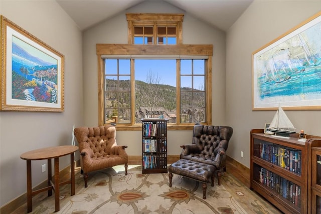 living area with a mountain view and vaulted ceiling