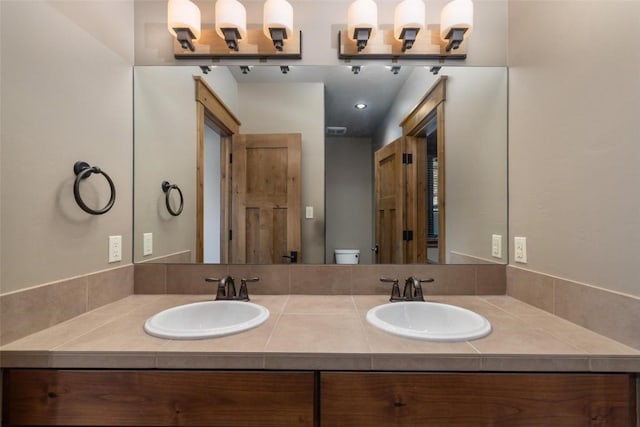 bathroom featuring vanity and toilet