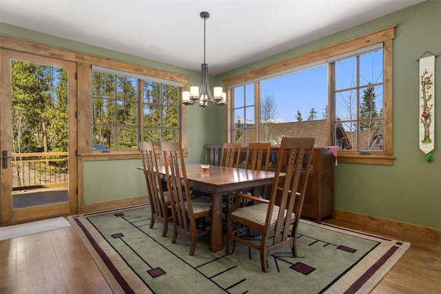 dining area featuring hardwood / wood-style flooring and a chandelier