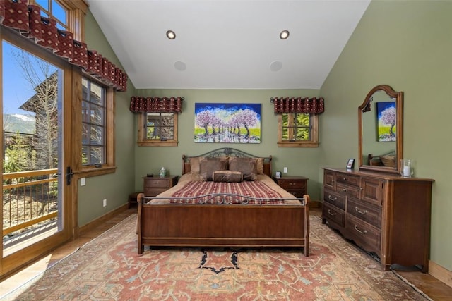 bedroom featuring multiple windows and lofted ceiling