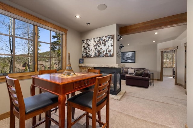 carpeted dining room featuring beam ceiling