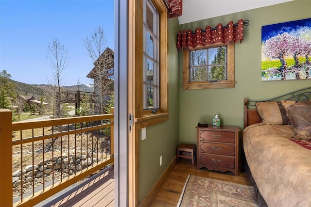 bedroom featuring hardwood / wood-style floors and multiple windows