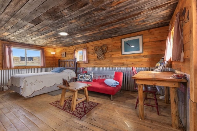 bedroom with hardwood / wood-style flooring, wood walls, and wood ceiling