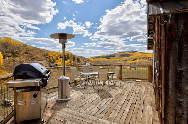 wooden deck featuring a mountain view and grilling area