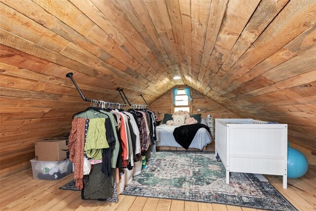 spacious closet with light wood-type flooring and vaulted ceiling