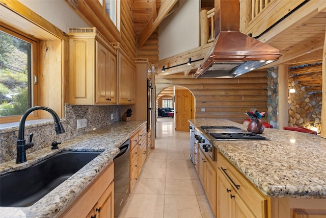 kitchen featuring sink, log walls, stainless steel appliances, light brown cabinets, and exhaust hood