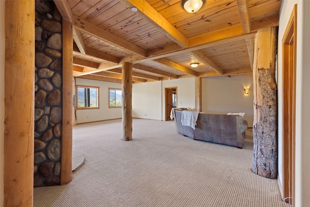 unfurnished living room featuring beam ceiling, light colored carpet, and wooden ceiling