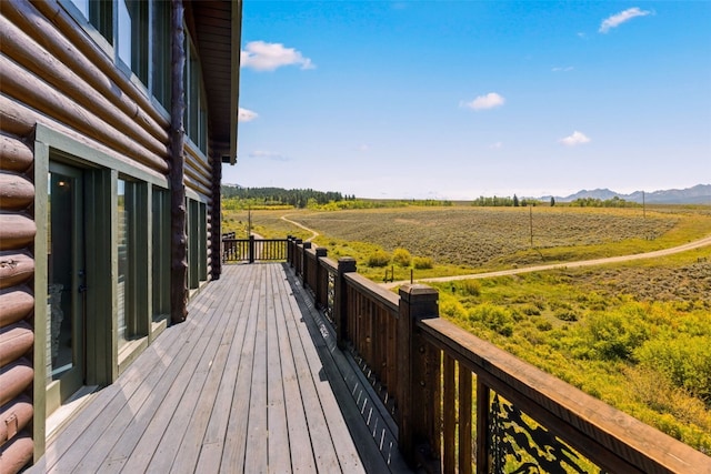 wooden deck featuring a mountain view and a rural view