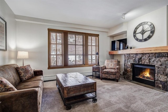 living area featuring a stone fireplace, carpet, and a baseboard radiator