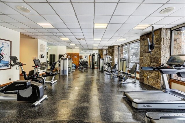 workout area with a paneled ceiling