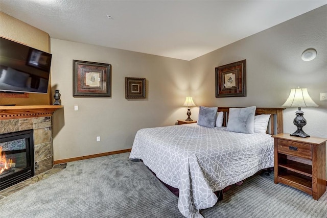 bedroom featuring light colored carpet and a fireplace