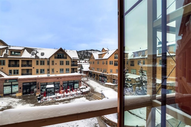 view of snow covered back of property