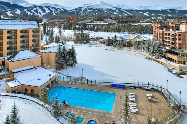 snowy aerial view with a mountain view