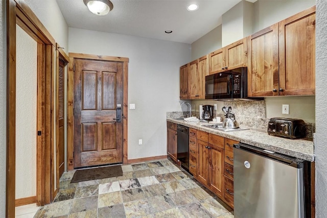 kitchen with black appliances and tasteful backsplash