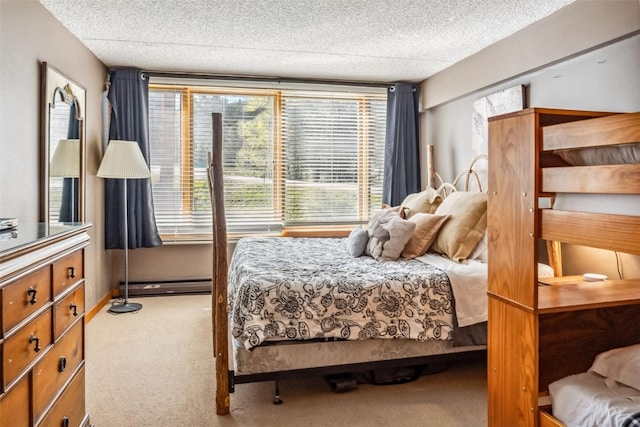 carpeted bedroom with a baseboard radiator and a textured ceiling