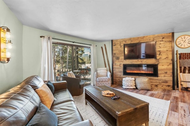 living room featuring a large fireplace and light hardwood / wood-style floors