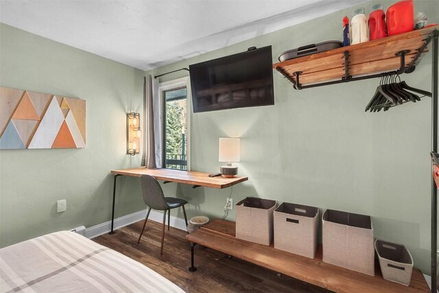 bedroom with dark hardwood / wood-style floors