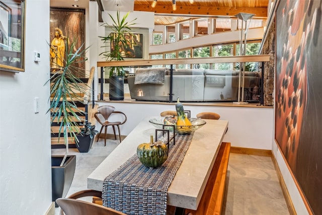 dining room featuring beamed ceiling and wooden ceiling